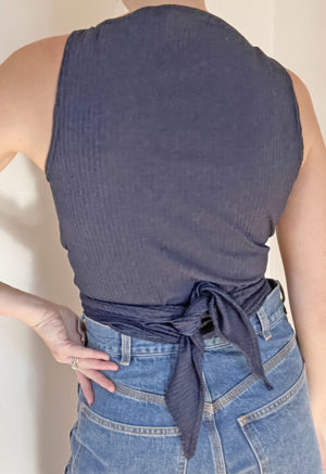 Back view of straight size model wearing Navy Everything Tank Top.