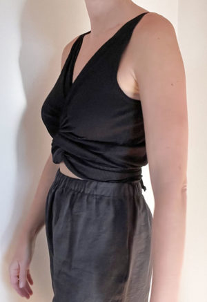 Side view of straight size model wearing Black Everything Tank Top.