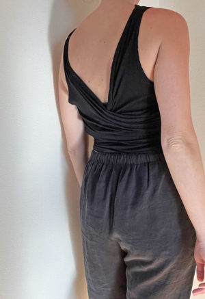 Back view of straight size model wearing Black Everything Tank Top.
