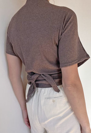 Back view of straight size model wearing Mauve Short-Sleeve Everything Top.