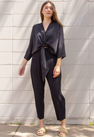 Front view of straight size model wearing Black Lyocell Bow Top.