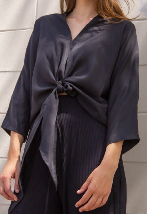 Front view of straight size model wearing Black Lyocell Bow Top.
