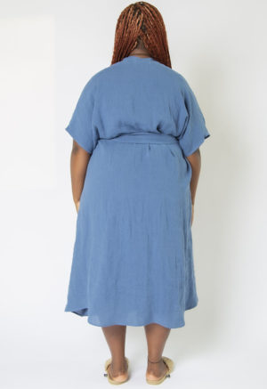 Back view of plus size model wearing Denim Linen Double V Swing Dress.