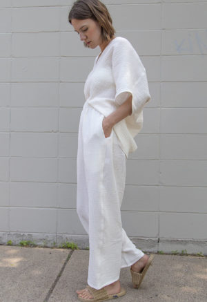 Side view of straight size model wearing Cream Gauze Double V Top.