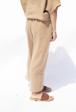 Side/back view of straight size model wearing Latte Linen Easy Wide-Leg Pants.
