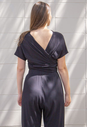 Back view of straight size model wearing Black Rib Everything Top.
