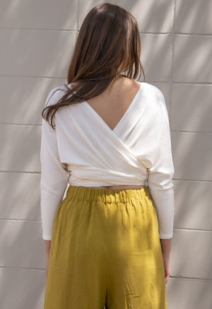 Back view of straight size model wearing Ivory Rib Everything Top.