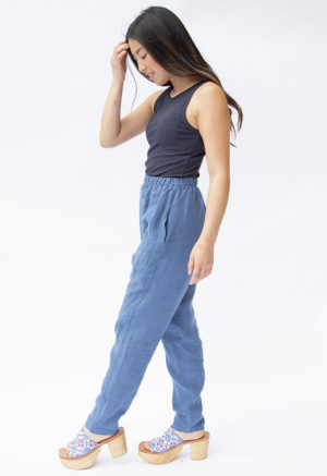 Side view of straight size model wearing Navy Rib Reversible Scoop Bodysuit.