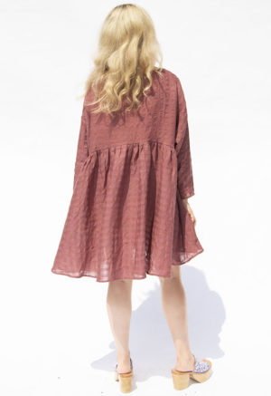 Back view of straight size model wearing Blush Check Short Oversized Dress.