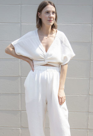 Front view of straight size model wearing Cream Gauze Short Sleeve Tie Top.