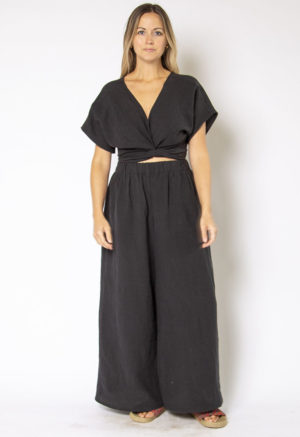 Front view of straight size model wearing Black Linen Short Sleeve Tie Top and Black Linen Extra Wide-Leg Pant.