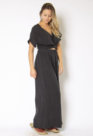 Front/side view of straight size model wearing Black Linen Short Sleeve Tie Top and Black Linen Extra Wide-Leg Pant.