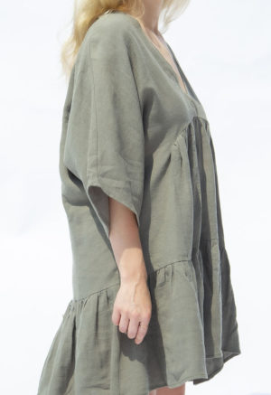 Side view of straight size model wearing Moss Linen Short Tiered Dress.