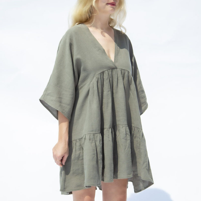 Front view of straight size model wearing Moss Linen Short Tiered Dress.