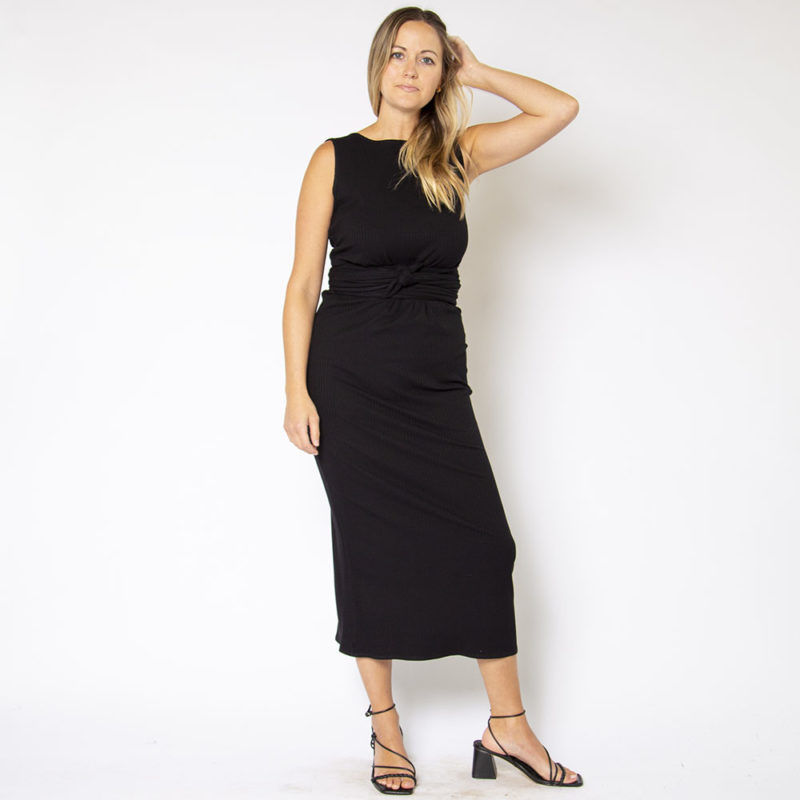 Front view of straight size model wearing Black Rib Sleeveless Wrap Dress.