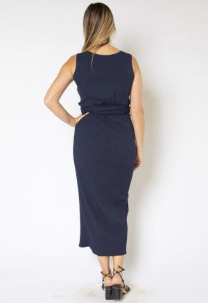 Back view of straight size model wearing Navy Sleeveless Wrap Dress.