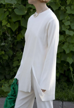 Side view of straight size model wearing Ivory Tunic Slit Rib Top.