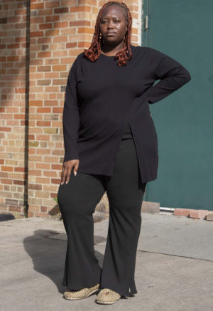 Front view of plus size model wearing Black Tunic Slit Rib Top.