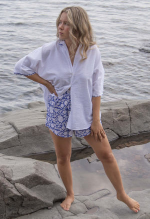 Front view of straight size model wearing White Seersucker Dolman Sleeve Button-Up and Blue & White Short Shorts.