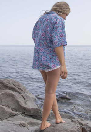 Back view of straight size model wearing Teal Floral Dolman Sleeve Button-Up and Ivory Rib Short Shorts.