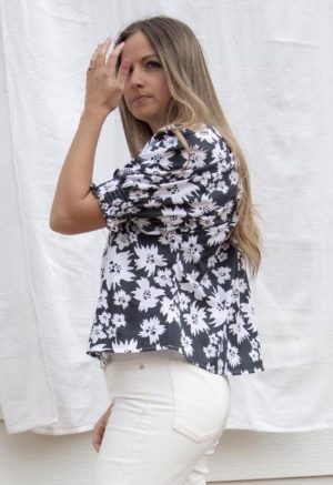 Side view of straight size model wearing Jungle Floral Short Sleeve Peasant Blouse.