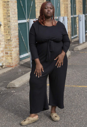 Front view of plus size model wearing Black Rib Long Sleeve Reversible Jumper.