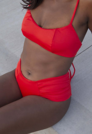 Front/side view of straight size model wearing Valentine Ruched Bikini Bottoms.