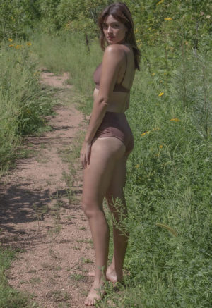 Side view of straight size model wearing Chestnut Ruched Bikini Bottoms.