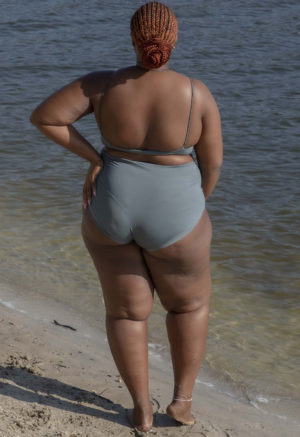 Back view of plus size model wearing Storm Spaghetti Strap V-Neck Top.