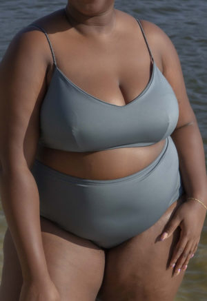 Front view of plus size model wearing Storm Spaghetti Strap V-Neck Top.