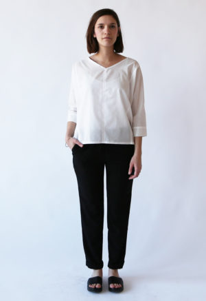 Front view of straight size model wearing White Calla Top.