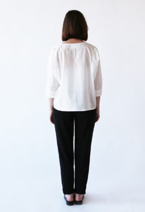 Back view of straight size model wearing White Calla Top.