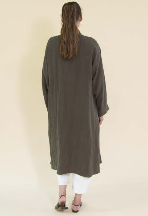 Women in dark green linen midi jacket worn over a white rib top and white jeans