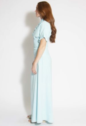 Side view of straight size model wearing Capri Blue Smocked-Waist Maxi Skirt.