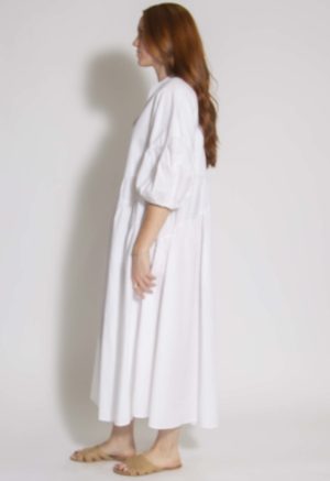 Side view of straight size model wearing White Circle Midi Dress.