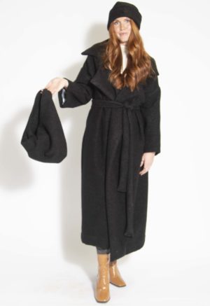 Front view of straight size model carrying Black Wool Boucle Small Tie Tote.