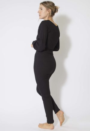 Side view of straight size model wearing Black Rib Leggings.