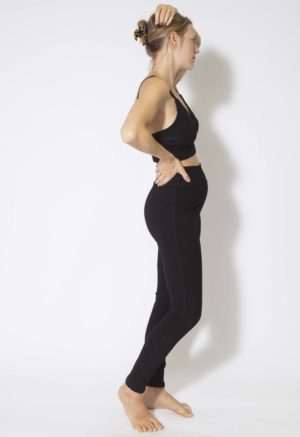 Side view of straight size model wearing Black Rib Leggings.