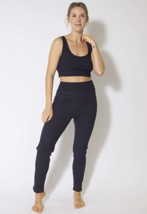 Front view of straight size model wearing Navy Rib Reversible Scoop Bralette and Rib Leggings.