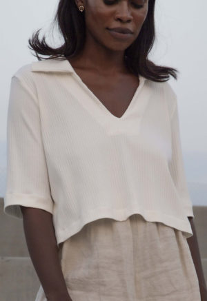 Front view of straight size model wearing Ivory Cropped Collar V-Neck Rib Top.