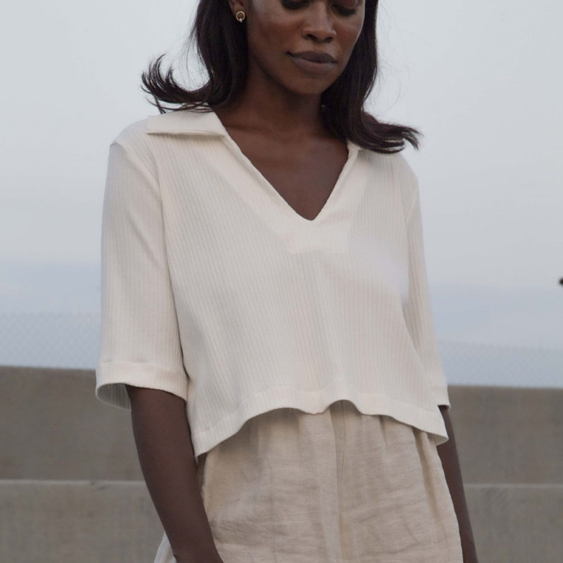 Front view of straight size model wearing Ivory Cropped Collar V-Neck Rib Top.