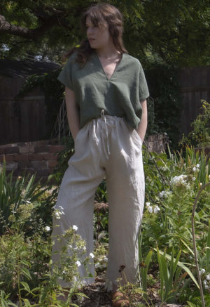 Front view of straight size model wearing Moss Linen Double V Cropped Top.
