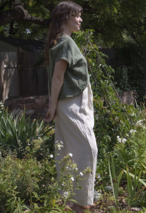 Side view of straight size model wearing Moss Linen Double V Cropped Top.