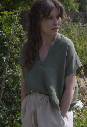 Front view of straight size model wearing Moss Linen Double V Cropped Top.