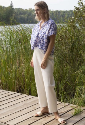 Front/side view of straight size model wearing Blue & White Floral Double V Cropped Top.