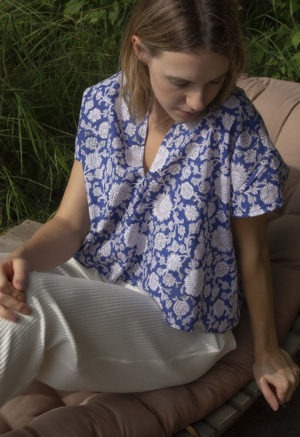 Front/side view of straight size model wearing Blue & White Floral Double V Cropped Top.