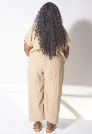 Back view of plus size model wearing Latte Linen Double V Cropped Top.