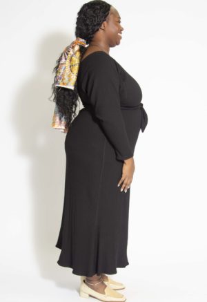 Side view of plus size model wearing Black Rib Everything Dress.