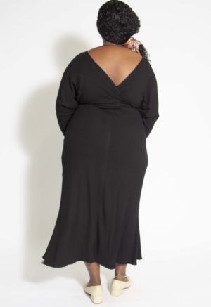 Back view of plus size model wearing Black Rib Everything Dress.