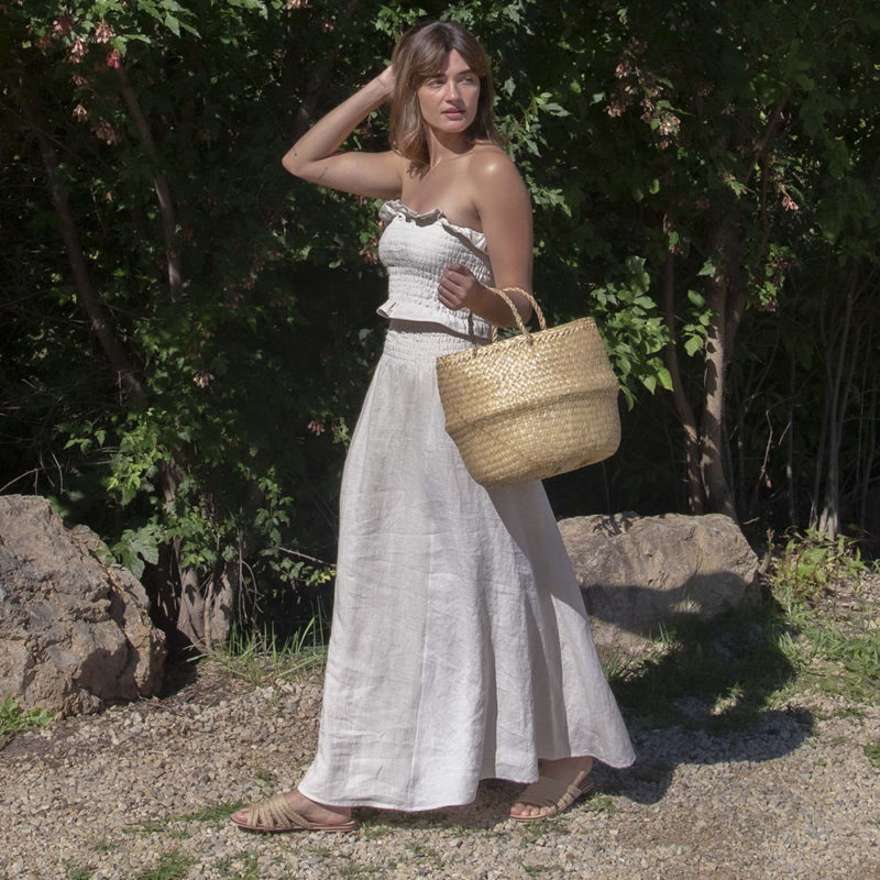 Front/side view of straight size model wearing Oatmeal Linen Ruched Swing Skirt.